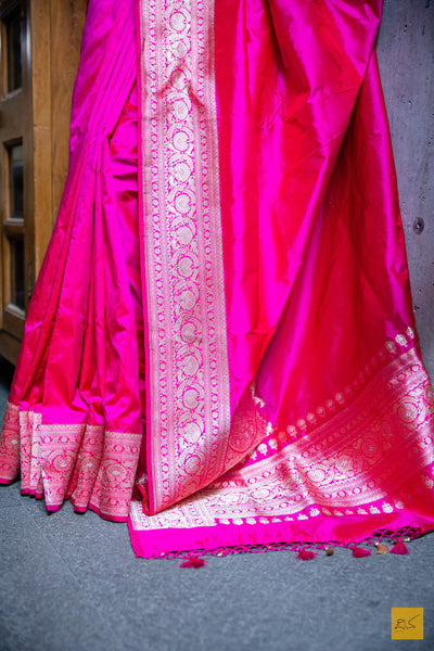 A PADMARAGA Banarasi Katan Silk Handwoven Saree is the pinnacle of luxury for those seeking a timeless and elegant look. This beautiful saree features intricate shikargah border and koniya that add a touch of sophistication to your wardrobe. Its soft texture and easy draping make it perfect for any special occasion. A shikargah blouse is adding to the beauty of this saree.  Fabric- Katan silk  Colour- Pink