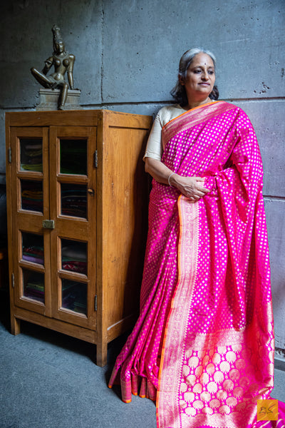 Exquisitely handwoven in Banarasi silk, this rani pink saree is perfect for any formal occasion. Its small motifs woven in cutwork style adds a stylish, traditional charm, while its luxuriously soft and effortless drape provides comfort and elegance.