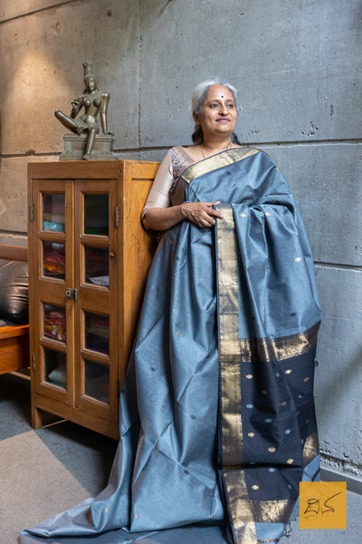 Indulge in the elegant look of our Gray-Black Maheshwari silk cotton saree. Perfect for both formal and casual occasions, this saree comes with a blouse for a complete look. Experience the benefits of comfort and style with this exquisite saree.