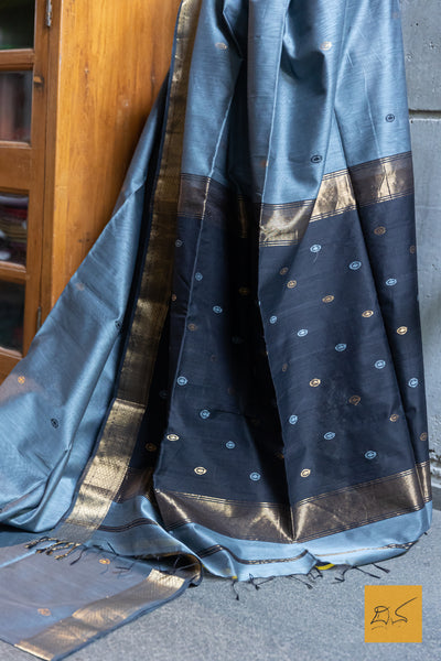 Indulge in the elegant look of our Gray-Black Maheshwari silk cotton saree. Perfect for both formal and casual occasions, this saree comes with a blouse for a complete look. Experience the benefits of comfort and style with this exquisite saree.