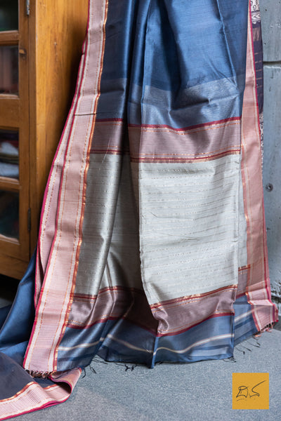 This stunning BLUE-MAGENTA MAHESHWARI SILK COTTON HANDWOVEN SAREE is a perfect combination of elegance and tradition. The high-quality fabric and handwoven craftsmanship make it suitable for both formal and casual occasions. With its vibrant colour and included blouse, this saree is sure to elevate your wardrobe.