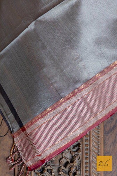 Experience the elegance of traditional Maheshwari silk and cotton with our BLACK-RED MAHESHWARI SILK COTTON HANDWOVEN SAREE. Perfect for casual or formal occasions, this saree comes with a matching blouse. Handwoven for a high-quality finish, it's a must-have addition to any wardrobe.