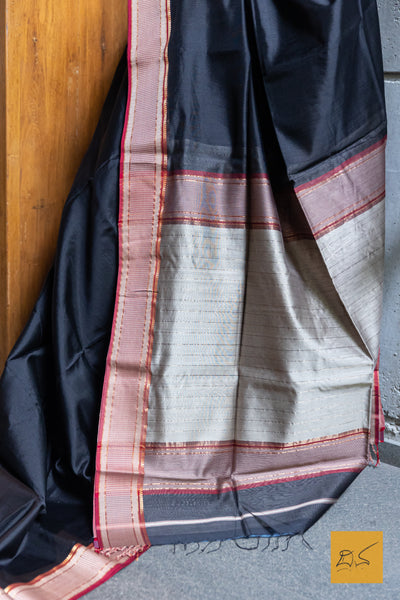 Experience the elegance of traditional Maheshwari silk and cotton with our BLACK-RED MAHESHWARI SILK COTTON HANDWOVEN SAREE. Perfect for casual or formal occasions, this saree comes with a matching blouse. Handwoven for a high-quality finish, it's a must-have addition to any wardrobe.
