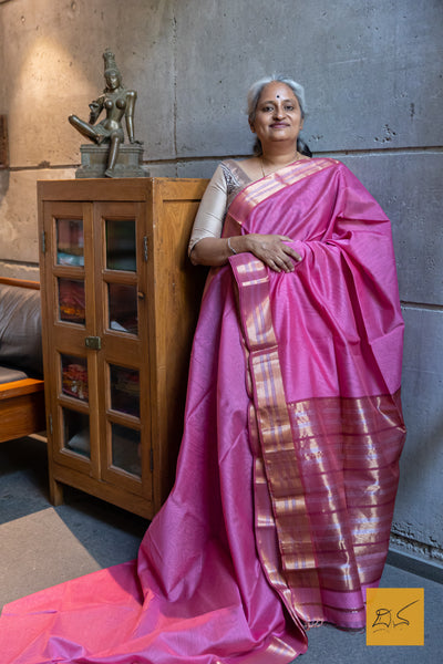 This Pink-Maroon Maheshwari Silk Cotton Handwoven Saree is a blend of soft silk and durable cotton, offering comfort and style. The intricate handwoven design showcases the rich heritage of Maheshwari silk, creating a timeless and elegant piece. Perfect for formal occasions or cultural events.