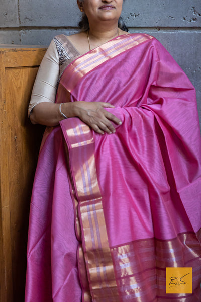 This Pink-Maroon Maheshwari Silk Cotton Handwoven Saree is a blend of soft silk and durable cotton, offering comfort and style. The intricate handwoven design showcases the rich heritage of Maheshwari silk, creating a timeless and elegant piece. Perfect for formal occasions or cultural events.