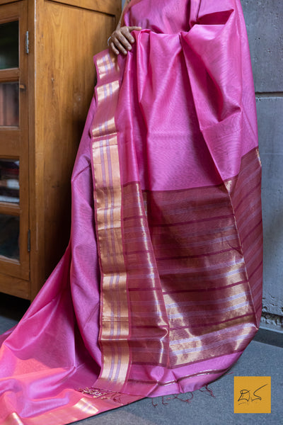 This Pink-Maroon Maheshwari Silk Cotton Handwoven Saree is a blend of soft silk and durable cotton, offering comfort and style. The intricate handwoven design showcases the rich heritage of Maheshwari silk, creating a timeless and elegant piece. Perfect for formal occasions or cultural events.