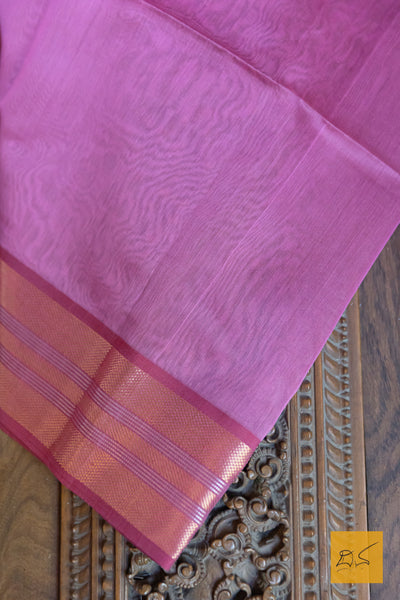 This Pink-Maroon Maheshwari Silk Cotton Handwoven Saree is a blend of soft silk and durable cotton, offering comfort and style. The intricate handwoven design showcases the rich heritage of Maheshwari silk, creating a timeless and elegant piece. Perfect for formal occasions or cultural events.