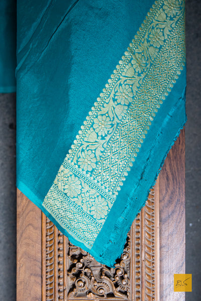 Invoke your inner beauty with this saree! Presenting this lovely red and green contrast georgette banarasi saree with zari jaal pattern. This saree is perfect for wedding receptions, house warming, mehendi, sangeeth and all other festivities.