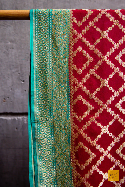 Invoke your inner beauty with this saree! Presenting this lovely red and green contrast georgette banarasi saree with zari jaal pattern. This saree is perfect for wedding receptions, house warming, mehendi, sangeeth and all other festivities.