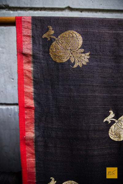 You are the MODEST!  Presenting this banarasi matka silk handwoven saree in dark brown and red. The saree has woven kadhwa buttas and the blouse is in red colour.