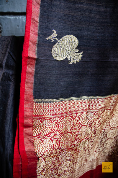 You are the MODEST!  Presenting this banarasi matka silk handwoven saree in dark brown and red. The saree has woven kadhwa buttas and the blouse is in red colour.