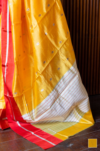 Bumblebee yellow handwoven chanderi silk saree with meenakari buttas and red mashru border.  This yellow tone Chanderi silk sare will add glamour to your wardrobe. Saree gets a completed look with the eknaliya buttas with red meenakari and red mashru border. The saree is extremely soft and very easy to drape.