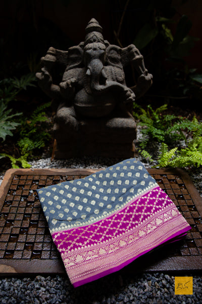 She is the successful one!  Presenting this lovely banarasi georgette saree in the shades of grey and pink. The sari has small buttas woven in cutwork style making it apt for this upcoming wedding and festive season. We would suggest minimal accessories. What will be your choice of accessories for this saree?