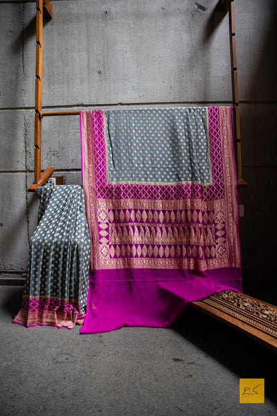 She is the successful one!  Presenting this lovely banarasi georgette saree in the shades of grey and pink. The sari has small buttas woven in cutwork style making it apt for this upcoming wedding and festive season. We would suggest minimal accessories. What will be your choice of accessories for this saree?