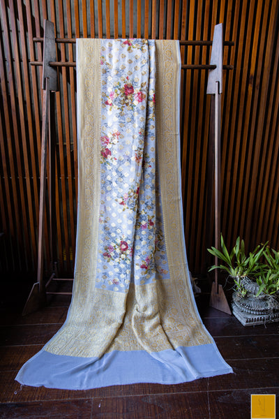 You are the torch bearer of our CULTURE! Presenting this banarasi georgette saree in grey tone. The saree has woven buttas and prints to giving a sophiticated look. Suits both formal and informal occassion.
