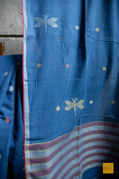 Neelaratna Hand spun Cotton Handwoven Jamdani Saree. A super soft hand spun cotton saree with handwoven jamdani weave. A perfect saree to  drape the whole day very comfortably.  Fabric- Hand spun Cotton Colour- Blue Length- 6.5m