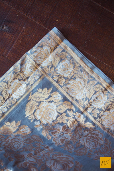 A lovely grey banarasi kora silk saree with small white buttas and exclusive sona and rupa border with rose buttas and pallu. New trend of Banarasi Saree designs, Banarasi Saree for artists, art lovers, architects, saree lovers, Saree connoisseurs, musicians, dancers, doctors, Banarasi silk saree, indian saree images, latest sarees with price, only saree images, new Banarasi saree design.