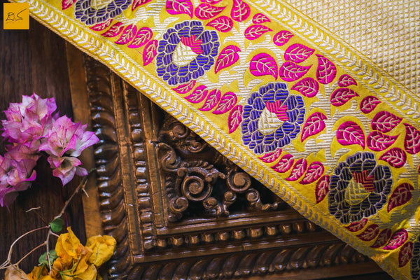 This is a gorgeous Banarasi Silk Saree with meenakari phulari border and pallu. The phulari border is so exquisite that it makes the saree stand out. The saree has small star meena buttas. The blouse is yellow in colour with the border. New trend of Banarasi Saree designs, Banarasi Saree for artists, art lovers, architects, saree lovers, Saree connoisseurs, musicians, dancers, doctors, Banarasi silk saree, indian saree images, latest sarees with price, only saree images, new Banarasi saree design.