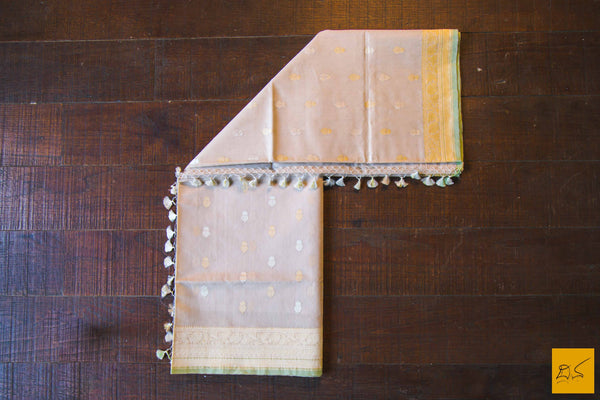 A lovely Banarasi cotton saree with white body and green slevedge. The body has golden silver buttas woven in it. The blouse is of golden brocade intricately woven. New trend of Banarasi Saree designs, Banarasi Saree for artists, art lovers, architects, saree lovers, Saree connoisseurs, musicians, dancers, doctors, Banarasi Katan silk saree, indian saree images, latest sarees with price, only saree images, new Banarasi saree design.