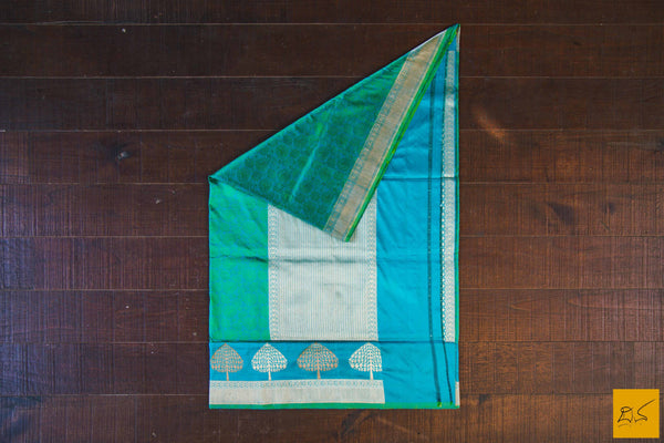 A wonderful banarasi silk tanchoi handwoven sari. The body has blue and green tanchoi work and the blue border has kadhwa motifs woven in antique zari and golden zari alternatively. The blouse has intricately woven zari brocade work with border. New trend of Banarasi Saree designs, Banarasi Saree for artists, art lovers, architects, saree lovers, Saree connoisseurs, musicians, dancers, doctors, Banarasi silk saree, indian saree images, latest sarees with price, only saree images, new Banarasi saree design.