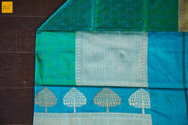 A wonderful banarasi silk tanchoi handwoven sari. The body has blue and green tanchoi work and the blue border has kadhwa motifs woven in antique zari and golden zari alternatively. The blouse has intricately woven zari brocade work with border. New trend of Banarasi Saree designs, Banarasi Saree for artists, art lovers, architects, saree lovers, Saree connoisseurs, musicians, dancers, doctors, Banarasi silk saree, indian saree images, latest sarees with price, only saree images, new Banarasi saree design.