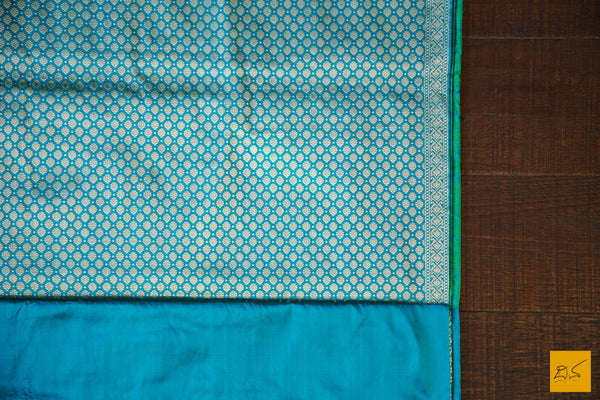 A wonderful banarasi silk tanchoi handwoven sari. The body has blue and green tanchoi work and the blue border has kadhwa motifs woven in antique zari and golden zari alternatively. The blouse has intricately woven zari brocade work with border. New trend of Banarasi Saree designs, Banarasi Saree for artists, art lovers, architects, saree lovers, Saree connoisseurs, musicians, dancers, doctors, Banarasi silk saree, indian saree images, latest sarees with price, only saree images, new Banarasi saree design.