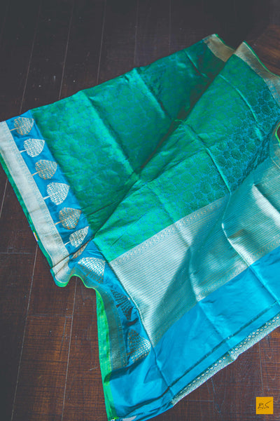 A wonderful banarasi silk tanchoi handwoven sari. The body has blue and green tanchoi work and the blue border has kadhwa motifs woven in antique zari and golden zari alternatively. The blouse has intricately woven zari brocade work with border. New trend of Banarasi Saree designs, Banarasi Saree for artists, art lovers, architects, saree lovers, Saree connoisseurs, musicians, dancers, doctors, Banarasi silk saree, indian saree images, latest sarees with price, only saree images, new Banarasi saree design.