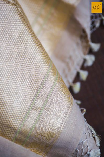 A lovely Banarasi cotton saree with white body and green slevedge. The body has golden silver buttas woven in it. The blouse is of golden brocade intricately woven. New trend of Banarasi Saree designs, Banarasi Saree for artists, art lovers, architects, saree lovers, Saree connoisseurs, musicians, dancers, doctors, Banarasi Katan silk saree, indian saree images, latest sarees with price, only saree images, new Banarasi saree design.