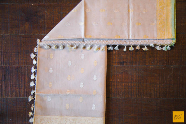 A lovely Banarasi cotton saree with white body and green slevedge. The body has golden silver buttas woven in it. The blouse is of golden brocade intricately woven. New trend of Banarasi Saree designs, Banarasi Saree for artists, art lovers, architects, saree lovers, Saree connoisseurs, musicians, dancers, doctors, Banarasi Katan silk saree, indian saree images, latest sarees with price, only saree images, new Banarasi saree design.