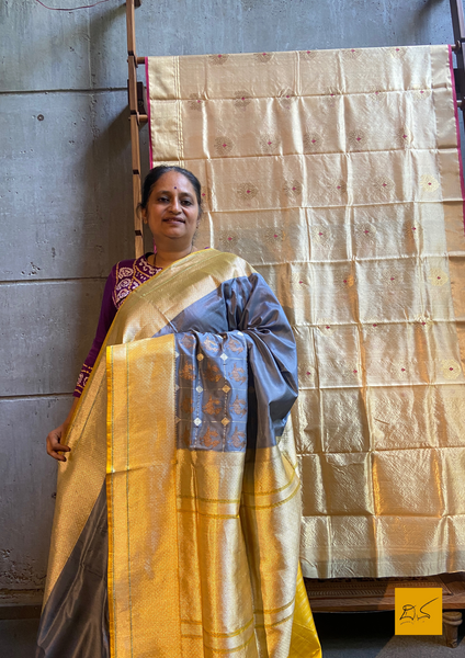 "I love really simple colours - lots of cream, beige, and grey. "  Does it sound familiar? Then this is your pick.  Presenting this banarasi katan silk handwoven saree in a unique combination of Grey and Yellow. This saree has a skirt border and the motifs are woven in kadhwa style. This saree is gorgeous as it is a kadhiyal too. Meaning the body colour and the border colours are different and it makes the saree to stand out and make it special. Needless to say, very soft and easy to drape.