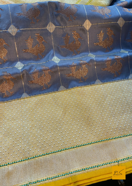 "I love really simple colours - lots of cream, beige, and grey. "  Does it sound familiar? Then this is your pick.  Presenting this banarasi katan silk handwoven saree in a unique combination of Grey and Yellow. This saree has a skirt border and the motifs are woven in kadhwa style. This saree is gorgeous as it is a kadhiyal too. Meaning the body colour and the border colours are different and it makes the saree to stand out and make it special. Needless to say, very soft and easy to drape.