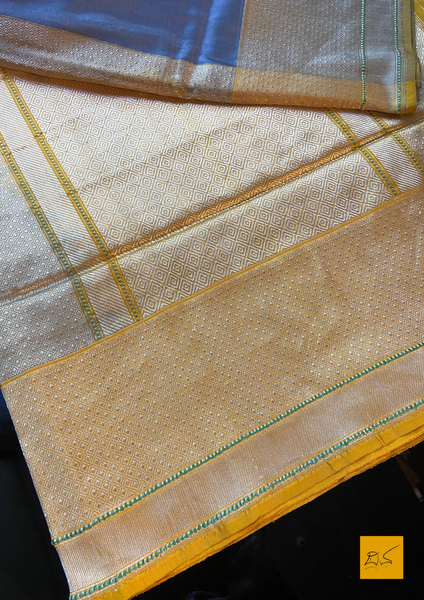 "I love really simple colours - lots of cream, beige, and grey. "  Does it sound familiar? Then this is your pick.  Presenting this banarasi katan silk handwoven saree in a unique combination of Grey and Yellow. This saree has a skirt border and the motifs are woven in kadhwa style. This saree is gorgeous as it is a kadhiyal too. Meaning the body colour and the border colours are different and it makes the saree to stand out and make it special. Needless to say, very soft and easy to drape.