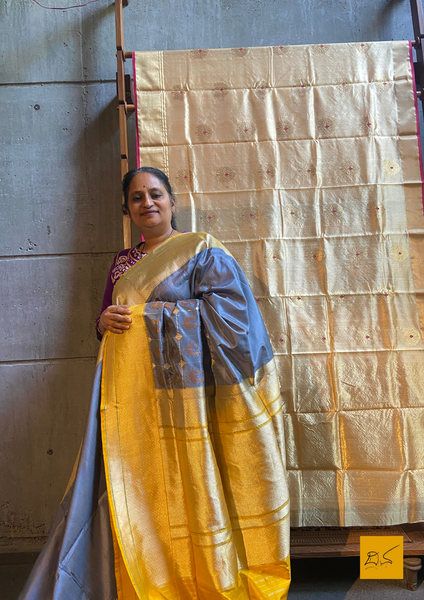 "I love really simple colours - lots of cream, beige, and grey. "  Does it sound familiar? Then this is your pick.  Presenting this banarasi katan silk handwoven saree in a unique combination of Grey and Yellow. This saree has a skirt border and the motifs are woven in kadhwa style. This saree is gorgeous as it is a kadhiyal too. Meaning the body colour and the border colours are different and it makes the saree to stand out and make it special. Needless to say, very soft and easy to drape.