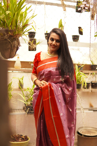 Light eminence purple chanderi handwoven silk saree with red mashru border. Presenting this unique purple tone chanderi silk handwoven saree with the red mashru border. The eknaliya buttas complete the saree look. Very soft and easy to drape.  Fabric- Pure silk  Colour-Purple and Red