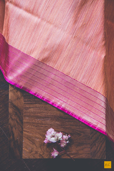 Peach and Pink.  A banarasi saree with matka silk body and pure katan silk border. The saree is special for its lovely meenakari border. This trendy banarasi saree has a katan silk border, pallu and blouse. The lower border has lovely colourful jaal weaving in multiple colours.  This saree goes well for both formal and informal gatherings. Accessorise this saree with a gajra and pearl accessories to complete the look.