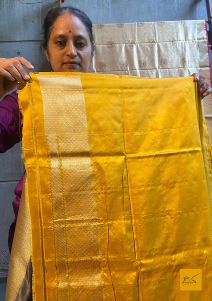 "I love really simple colours - lots of cream, beige, and grey. "  Does it sound familiar? Then this is your pick.  Presenting this banarasi katan silk handwoven saree in a unique combination of Grey and Yellow. This saree has a skirt border and the motifs are woven in kadhwa style. This saree is gorgeous as it is a kadhiyal too. Meaning the body colour and the border colours are different and it makes the saree to stand out and make it special. Needless to say, very soft and easy to drape.