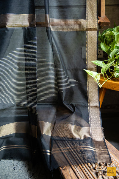 Luxuriate in the exceptional craftsmanship of this Classy Black saree. Boasting a very unique design, this maheshwari saree is handwoven from black silk cotton and features a temple design. An exquisite embodiment of heritage and sophistication, it will make you the envy of the room.