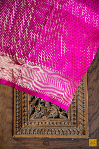 Designed with a stunning red and pink hue, this luxurious SAMANVITA saree is crafted from handwoven mashru banarasi silk and highlighted with intricate zari and pink buttas. Its supremely soft drape will feel exquisite against your skin and is complete with a shimmering brocade blouse. Exquisite and exclusive, this saree is the ultimate expression of luxury.  Fabric- Mashru silk  Colour- Red and pink