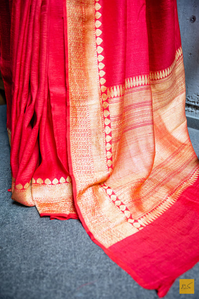 Experience the opulence of a classic Red Banarasi Tussar Silk Saree. Handwoven to perfection for unparalleled comfort, this timeless piece of art is designed to be light and airy for an effortless drape, while its classic styling exudes a subtle elegance. A truly distinguished and luxurious garment.