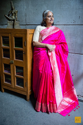 A PADMARAGA Banarasi Katan Silk Handwoven Saree is the pinnacle of luxury for those seeking a timeless and elegant look. This beautiful saree features intricate shikargah border and koniya that add a touch of sophistication to your wardrobe. Its soft texture and easy draping make it perfect for any special occasion. A shikargah blouse is adding to the beauty of this saree.  Fabric- Katan silk  Colour- Pink