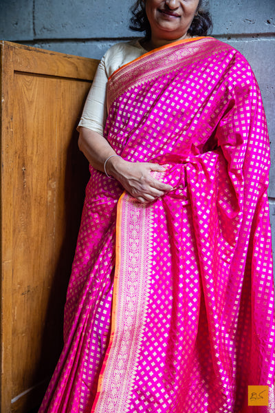 Exquisitely handwoven in Banarasi silk, this rani pink saree is perfect for any formal occasion. Its small motifs woven in cutwork style adds a stylish, traditional charm, while its luxuriously soft and effortless drape provides comfort and elegance.