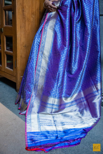 Experience the exquisite craft of luxury with our PRAHARSHITA Banarasi Katan Silk Handwoven Saree. Sumptuously handwoven from the finest blue katan silk, it seamlessly drapes the body with effortless grace. Delicate zari tanchoi adorns this beauty with a matching tanchoi silk blouse, captivating you with its undeniable sophistication.  Fabric- Katan silk