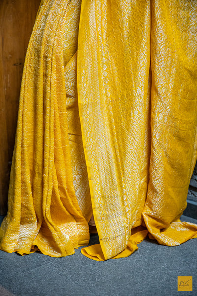 Perfect for any special occasion, the KAMAKSHI Banarasi Georgette Saree is an elegant and sophisticated statement piece. Boasting an exquisite yellow brocade georgette fabric and intricate designs, this saree is sure to be a showstopper at any event. Easy to drape and exuding a chic and classy look, the KAMAKSHI Banarasi Georgette Saree is an ideal choice for all of your festive and formal needs.