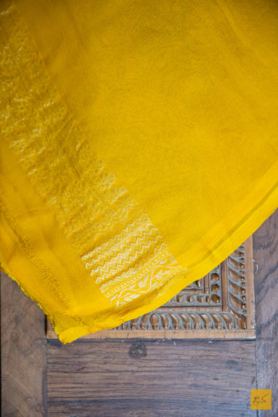 Perfect for any special occasion, the KAMAKSHI Banarasi Georgette Saree is an elegant and sophisticated statement piece. Boasting an exquisite yellow brocade georgette fabric and intricate designs, this saree is sure to be a showstopper at any event. Easy to drape and exuding a chic and classy look, the KAMAKSHI Banarasi Georgette Saree is an ideal choice for all of your festive and formal needs.