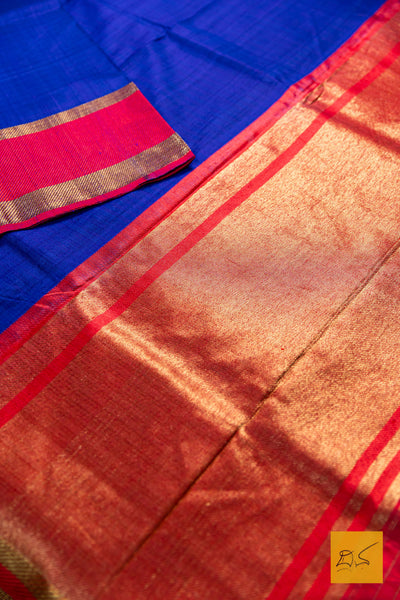 Close-up of a blue and red saree with a gold border