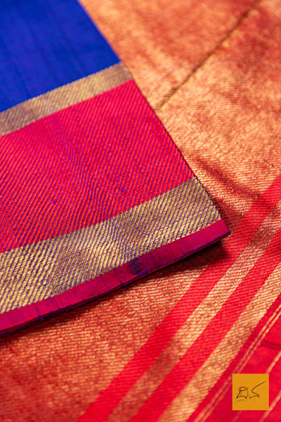 Close-up of a colorful fabric with red, blue, and gold patterns.