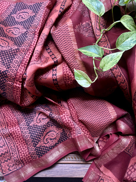This saree has a beautiful blend of red and peach in its Bagh hand printed design. The saree is made of Maheshwari silk cotton to give it a luxurious feel and look. Enjoy a special occasion wearing this beautiful saree.  Fabric- Silk Cotton