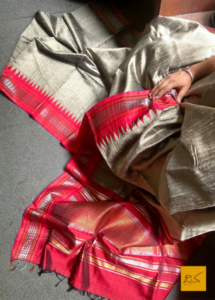 Chandravadana is a luxurious dupion silk saree with a beautiful grey and red colour combination. This saree is handwoven for a delicate, authentic temple border. A perfect choice for a special occasion or everyday grace.  Fabric-Raw(Dupion)Silk.