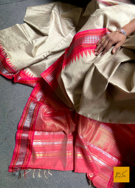 Saudamini is a beautiful, handwoven dupion silk sari with a temple border. The bold combination of the beige and red make this sari perfect for any occasion. Crafted with expert artisans, this sari is sure to turn heads.  Fabric-Raw (Dupion) Silk.