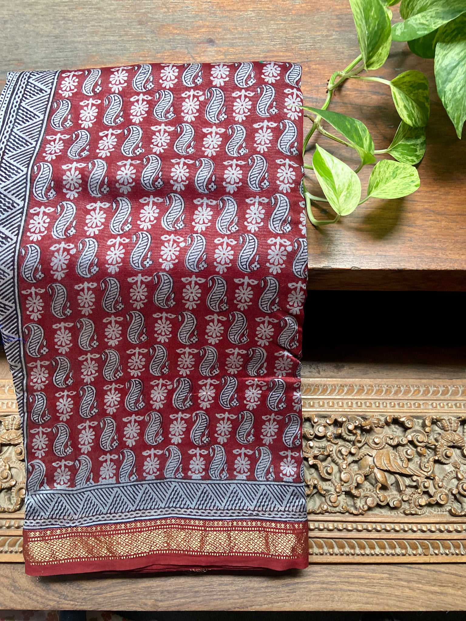 This traditional Maroon- Blue Bagh printed Maheshwari Saree is a classic combination of timeless elegance and modern fashion. Hand-printed in traditional bagh style in Madhya Pradesh and woven in Maheshwar, this saree is made from silk cotton and is easy to drape. It is a must-have for any wardrobe.